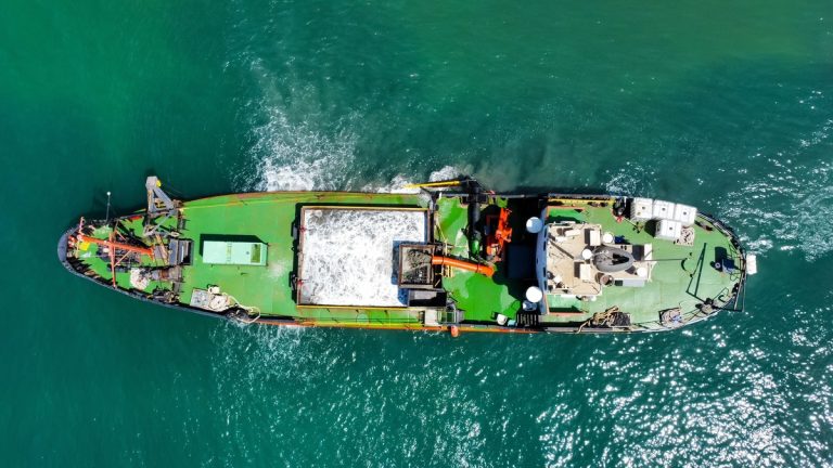Aerial shot of a cargo ship on the ocean, showcasing shipping and marine transport