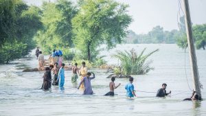 People wading through dangerous moving water