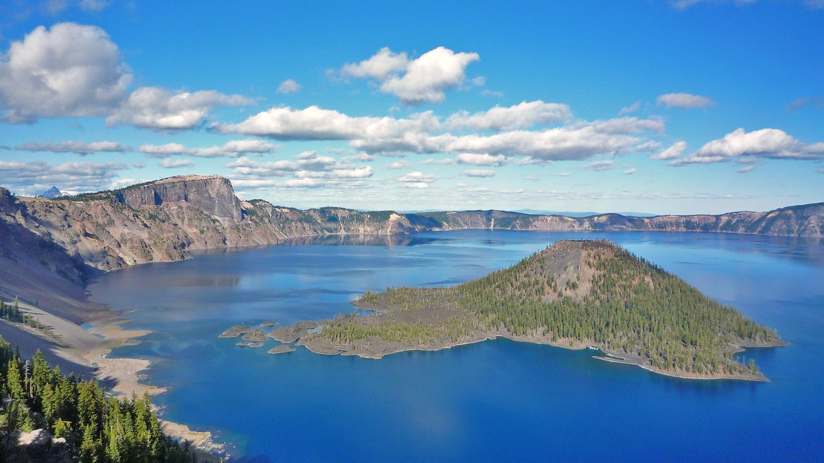 Crater Lake and Wizard Island beneath a blue sky in Oregon