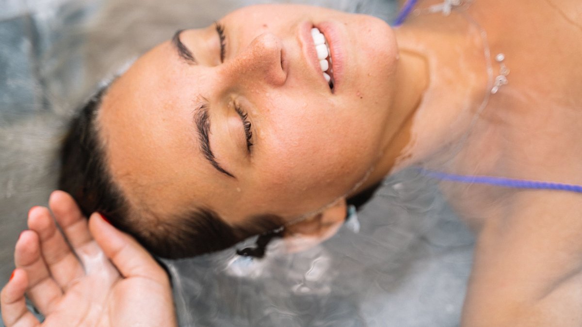 Woman floating calmly with her eyes closed