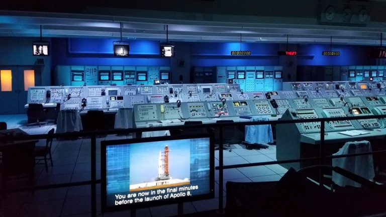 A mission control room filled with monitoring screens