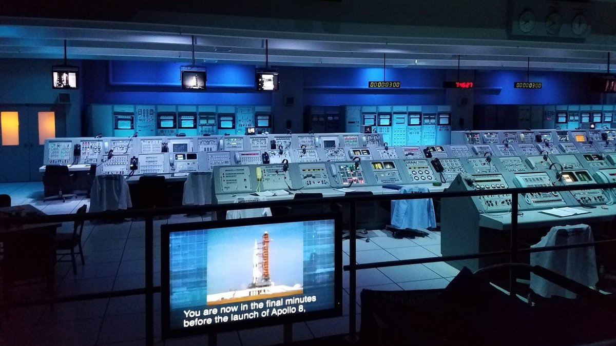 A mission control room filled with monitoring screens