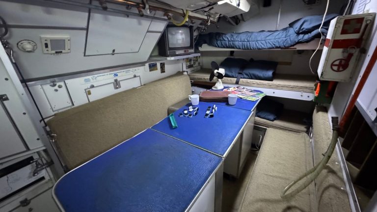 The compact interior of a vintage space capsule simulator