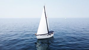 A sailboat glides peacefully on Lake Michigan under a clear summer sky