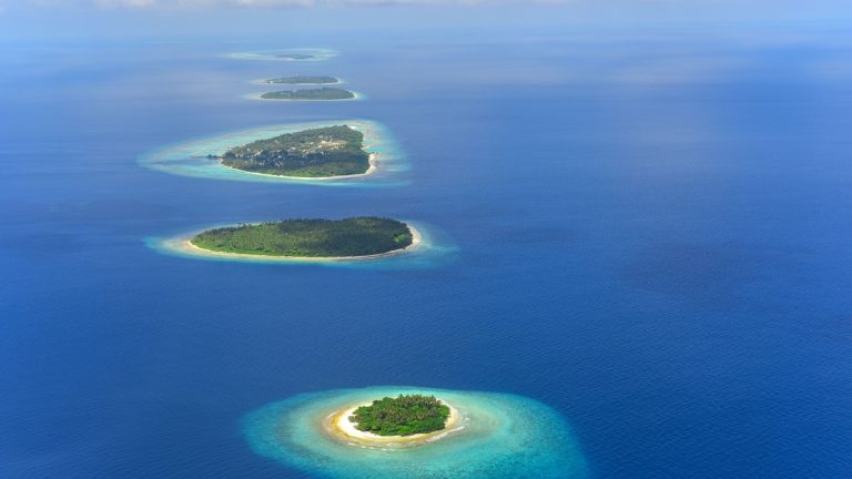 Stunning aerial shot of a chain of tropical islands in the Maldives surrounded by turquoise waters