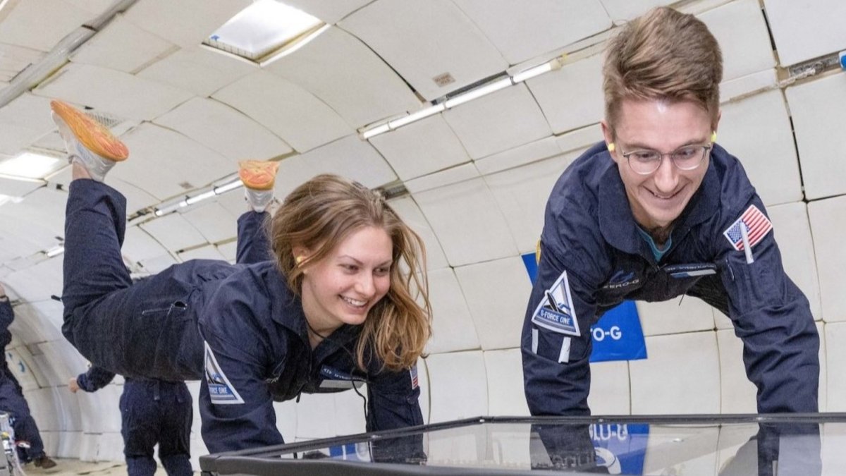 Researchers floating inside an aircraft during a parabolic microgravity flight