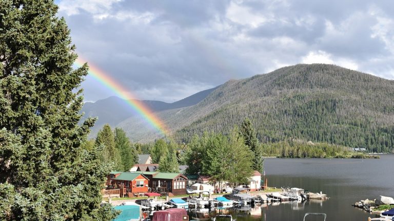 Grand Lake in Colorado beneath a rainbow