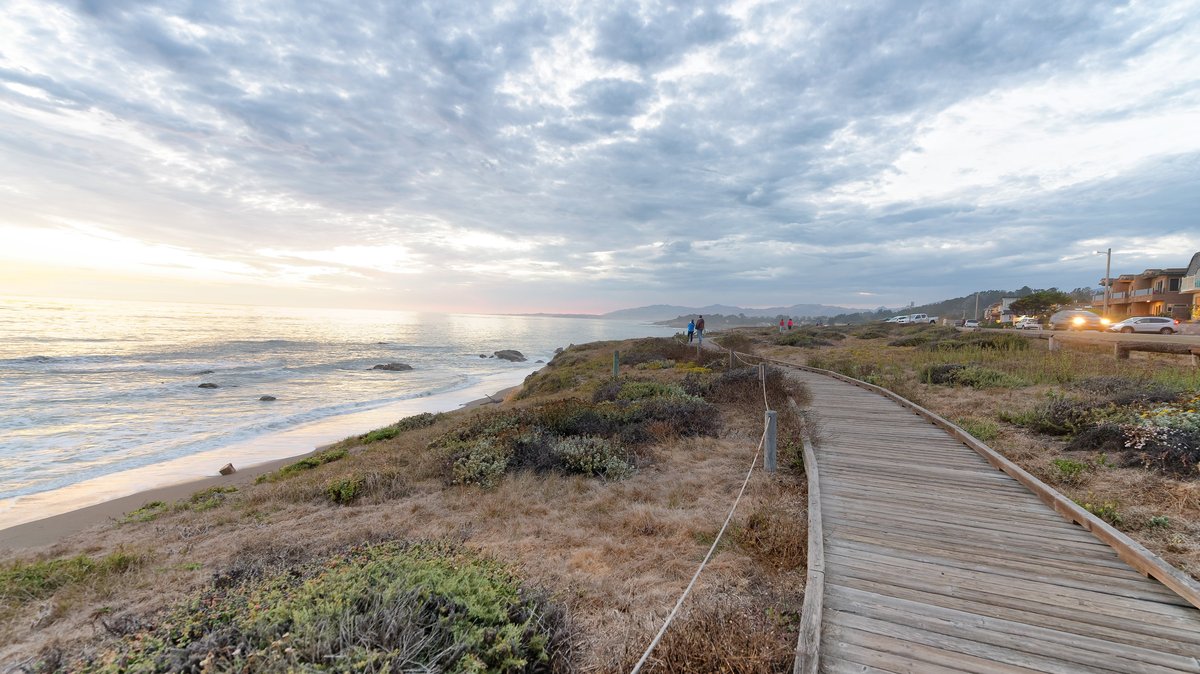 Cambria wooden walkway along the sea at sunset, California-USA