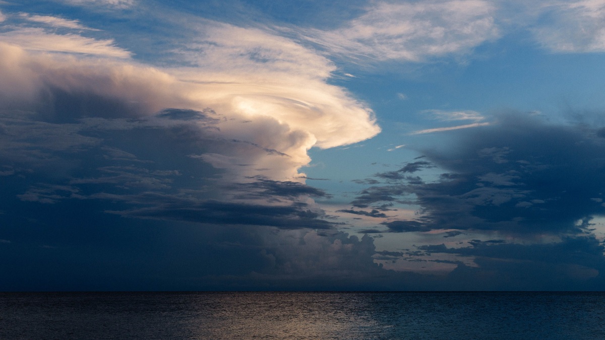 Storm clouds over a calm tropical ocean in the doldrums