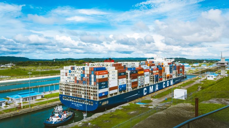 A cargo ship moving through the Panama Canal