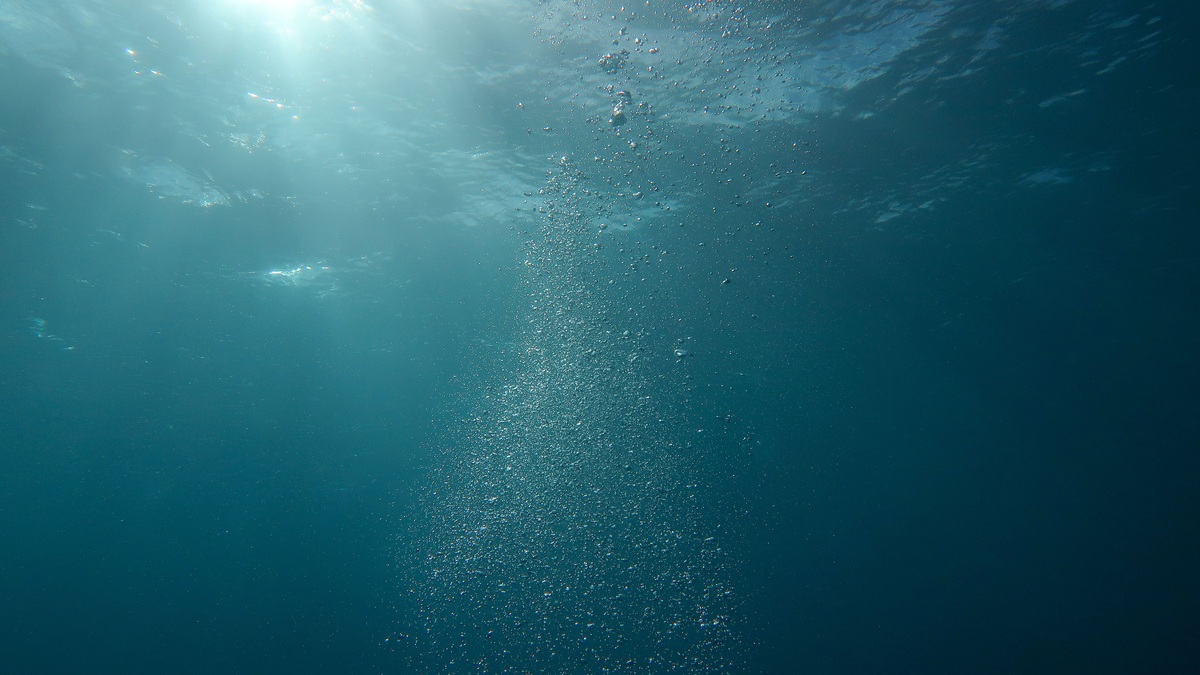 Sunlight penetrating deep blue ocean water