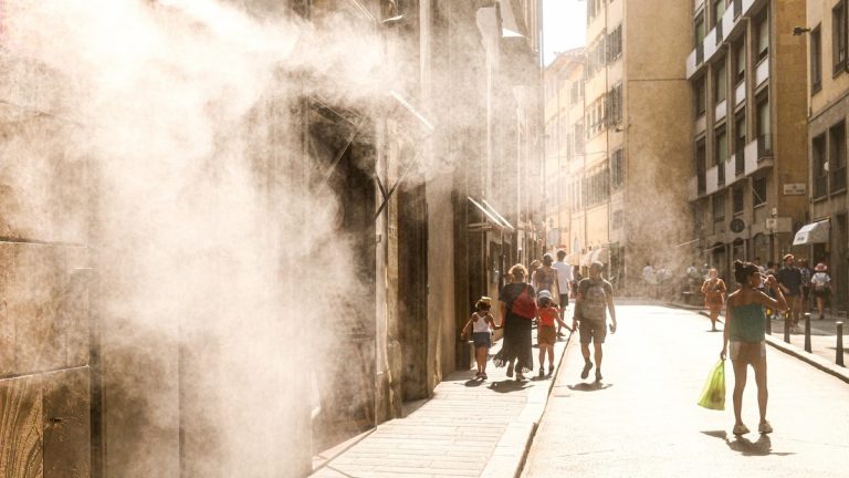 People cooling off in city mist during extreme heat