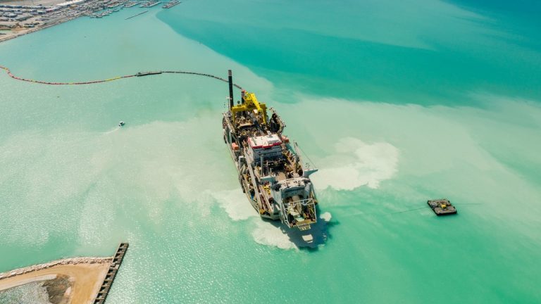 A dredging vessel working in shallow coastal water