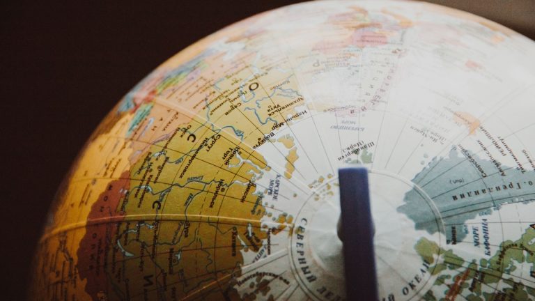A globe marked with geographic coordinate lines