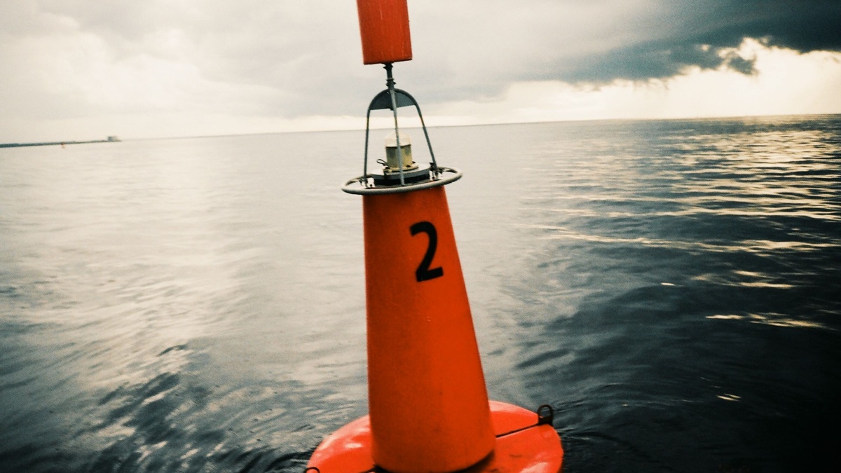 An ocean observation buoy beneath a cloudy sky