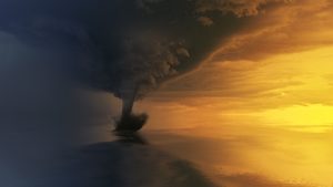 A waterspout extending from a storm cloud to the ocean
