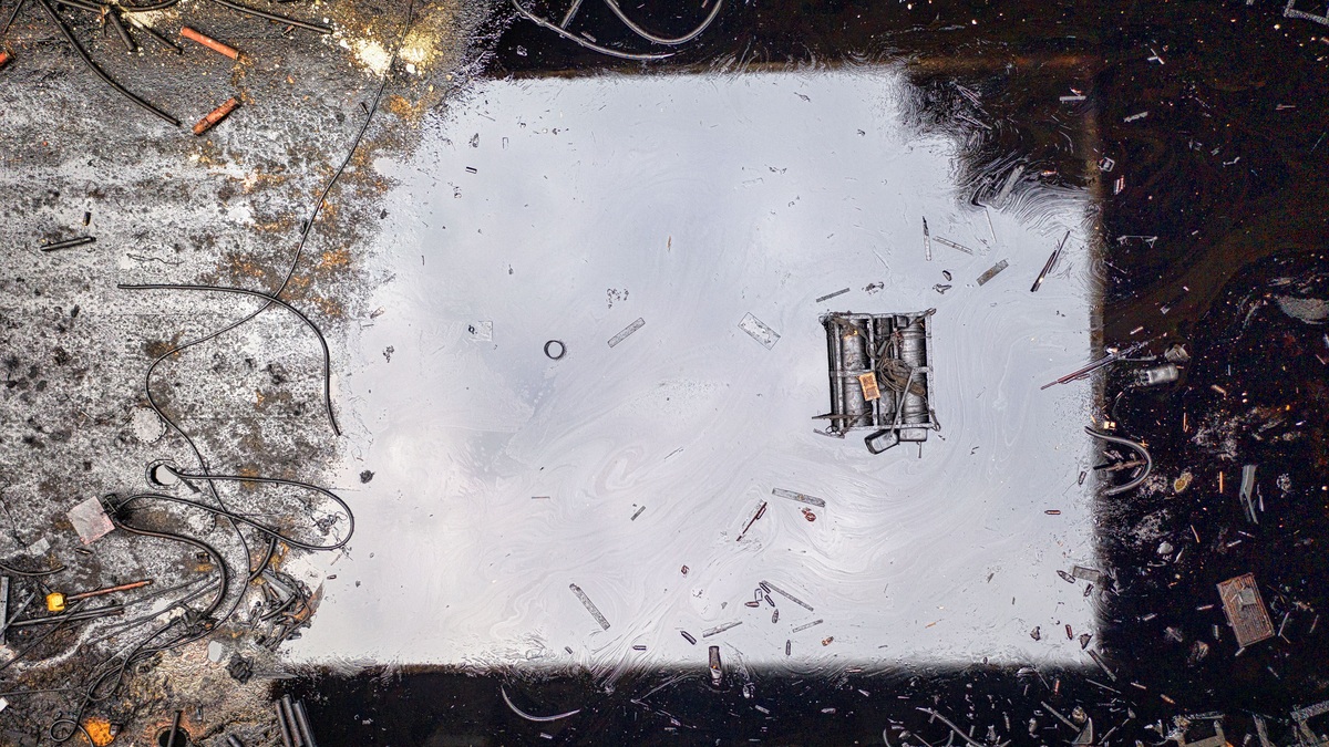 Oil contamination visible on the surface of dark water