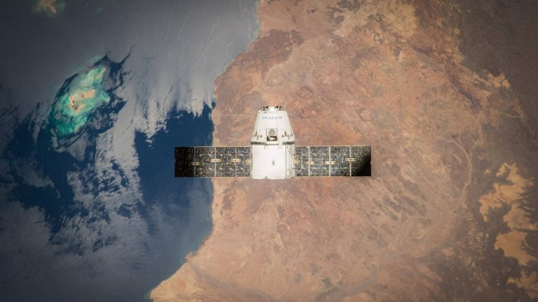 Satellite in orbit with detailed view of Earth and ocean below